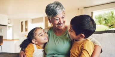Older woman hugging her grandkids