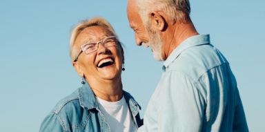 Senior man and woman laughing outside